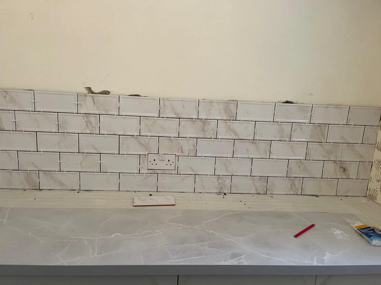 Kitchen wall tiling in progress